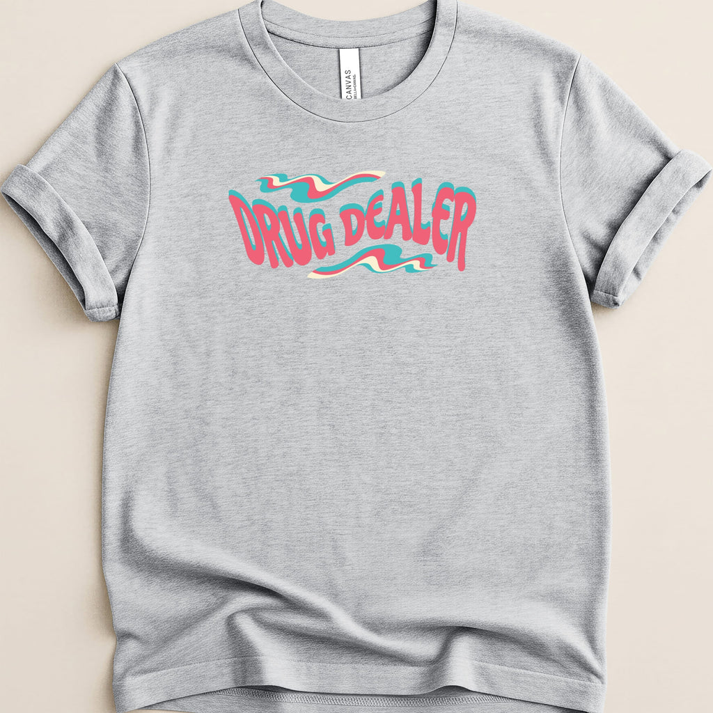 Gray t-shirt with "DRUG DEALER" text in a wavy, pastel pink and blue font.