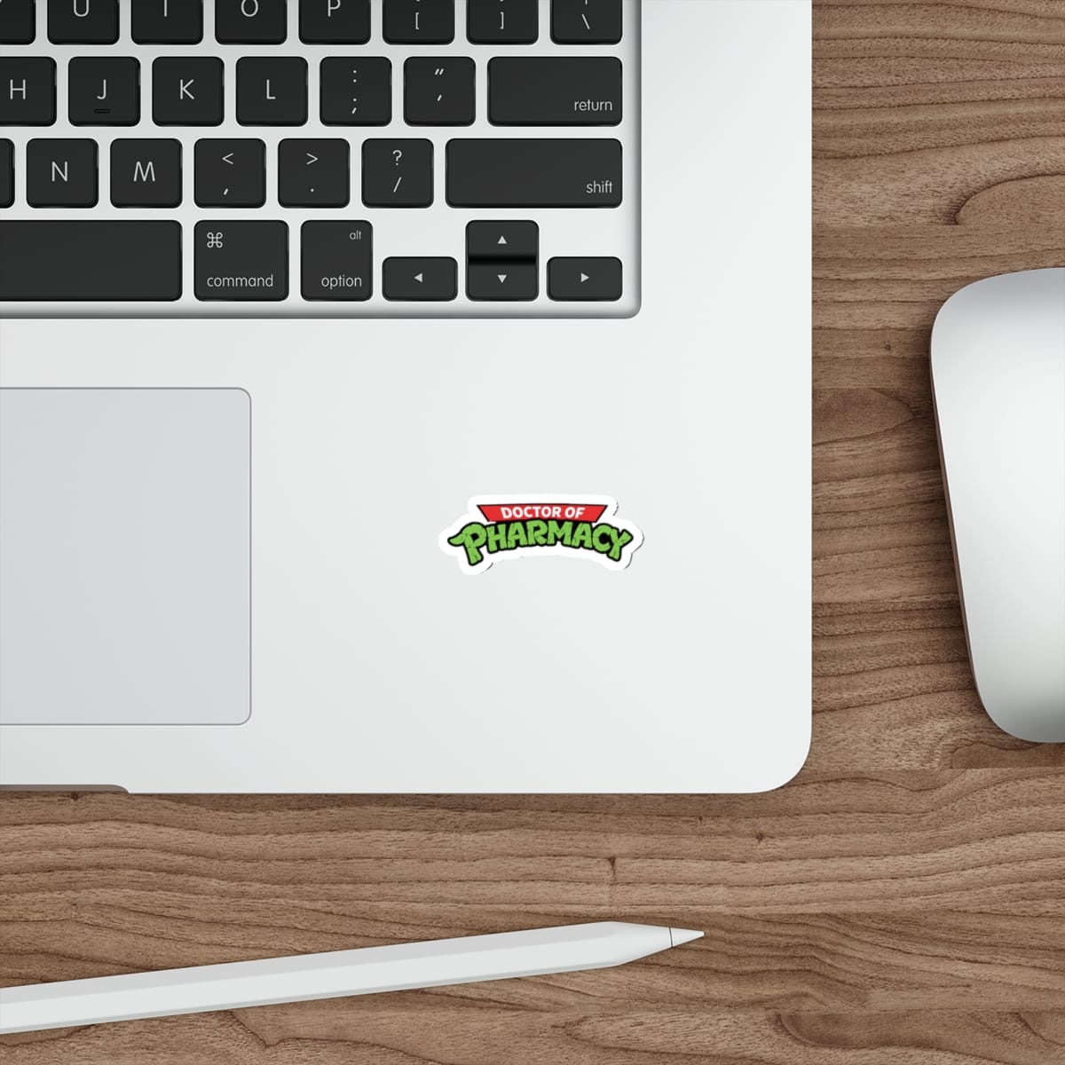 Sticker with "Doctor of Pharmacy" text on a laptop keyboard.