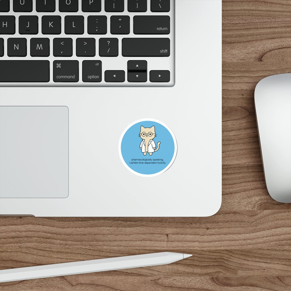 Round sticker of a cat in glasses with text "pharmacologically speaking, i exhibit time-dependent toxicity."