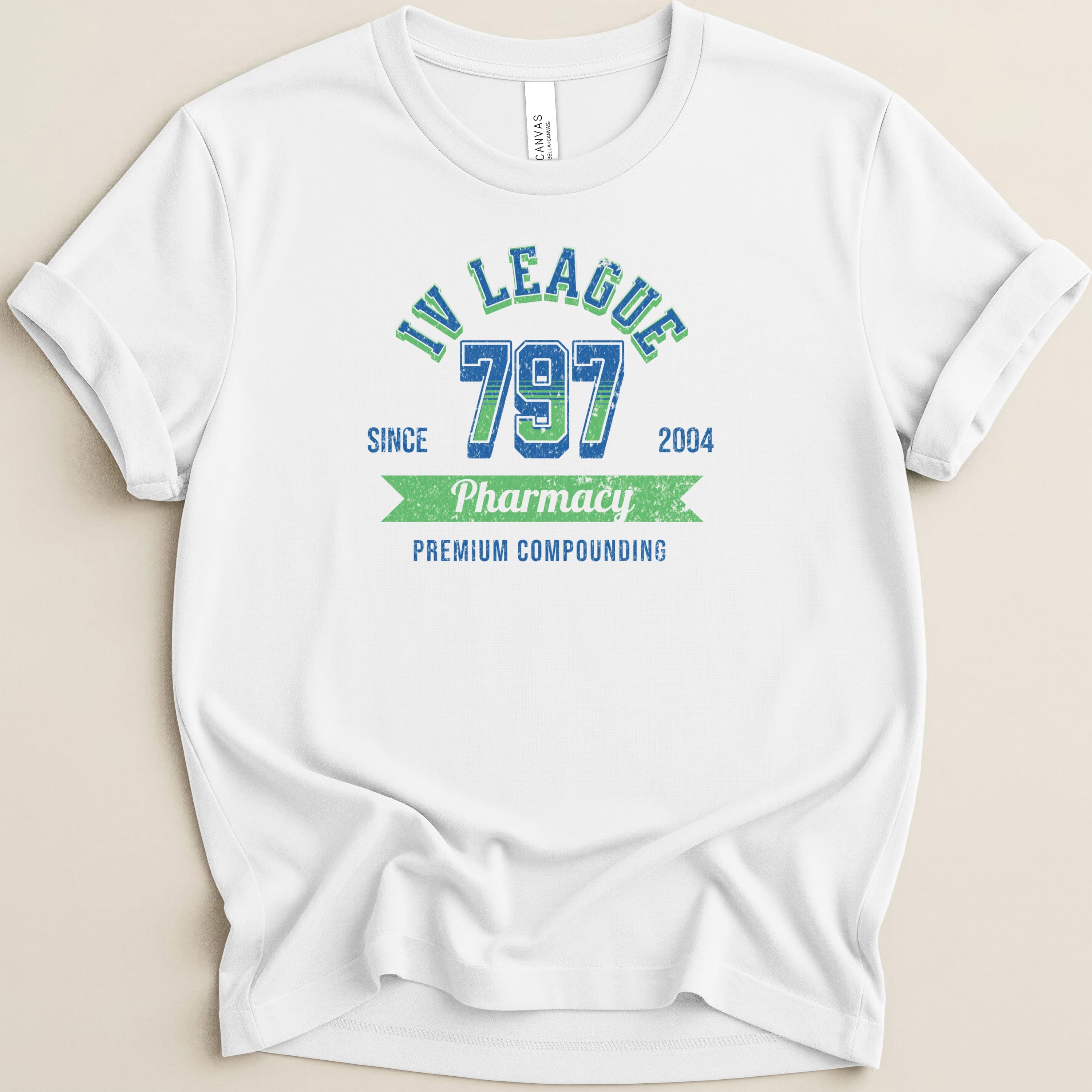 White t-shirt with "IV League 797 Pharmacy Premium Compounding" text.