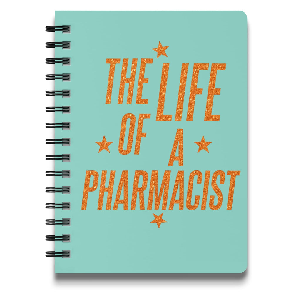 Teal spiral-bound notebook with "The Life of a Pharmacist" in orange glitter text.