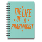 Teal spiral-bound notebook with "The Life of a Pharmacist" in orange glitter text.