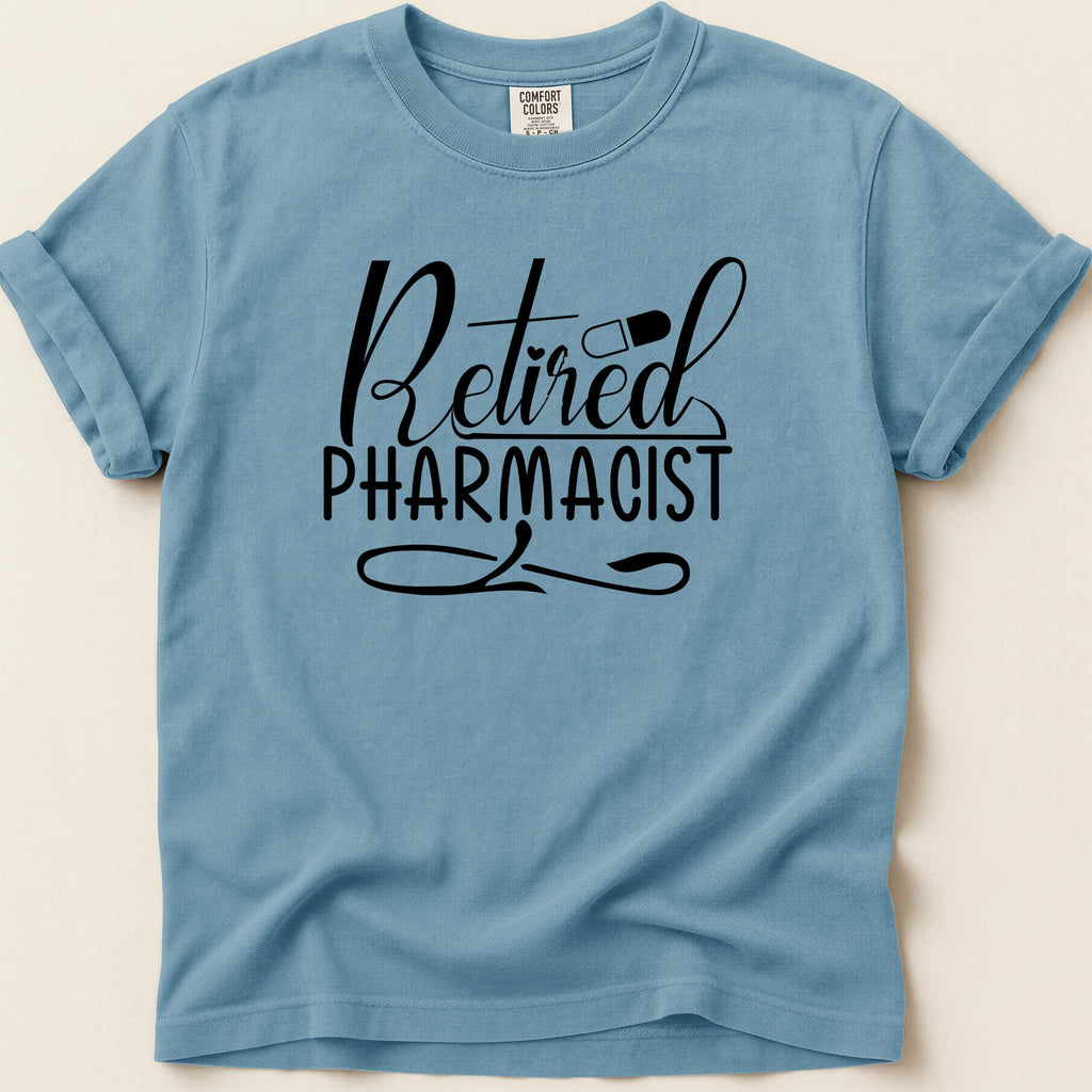 Blue t-shirt with "Retired Pharmacist" text and a pill graphic.