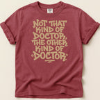 Maroon t-shirt with tan text reading, "Not that kind of doctor, the other kind of doctor."