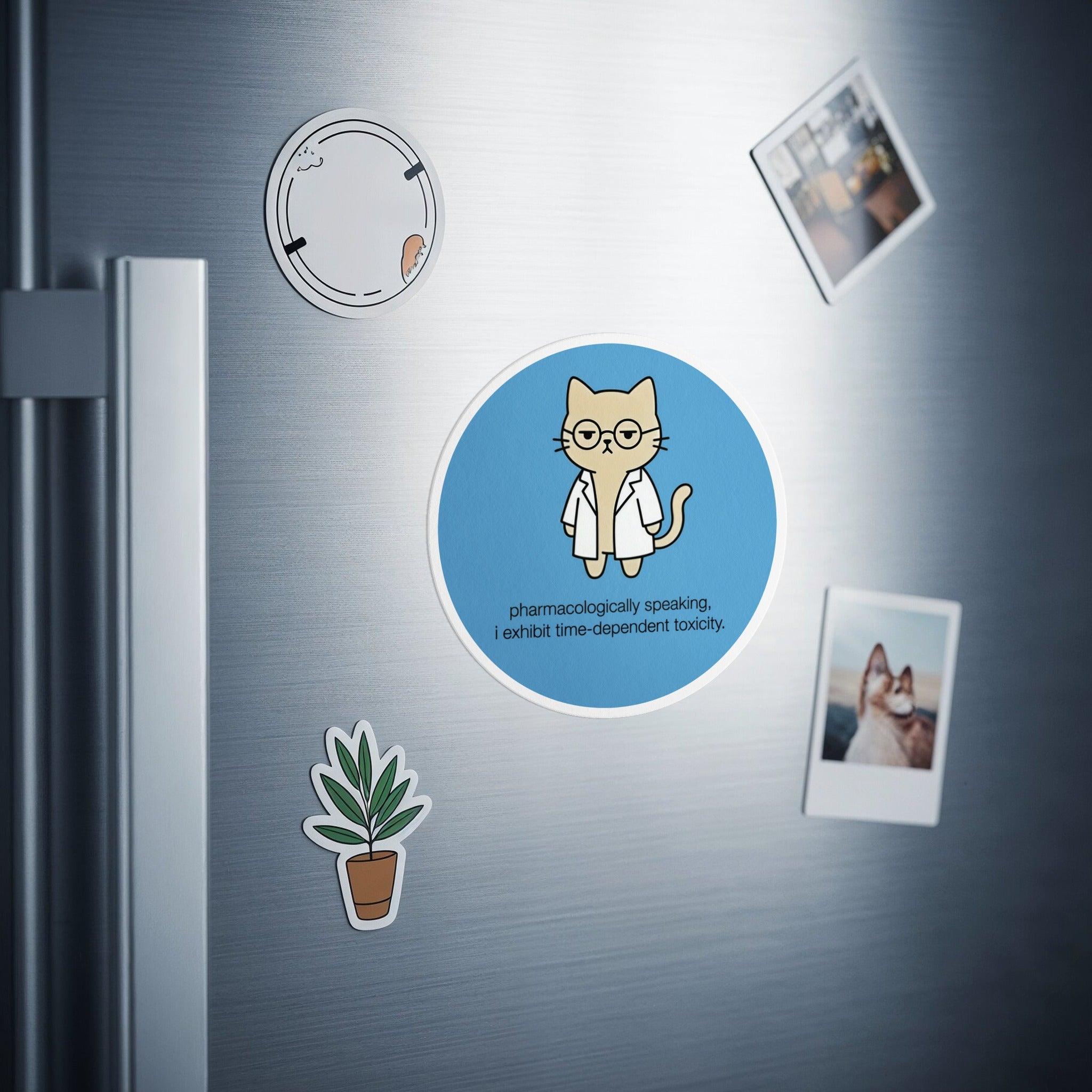 Round sticker with a cat wearing glasses, text reads "pharmacologically speaking, I exhibit time-dependent toxicity."