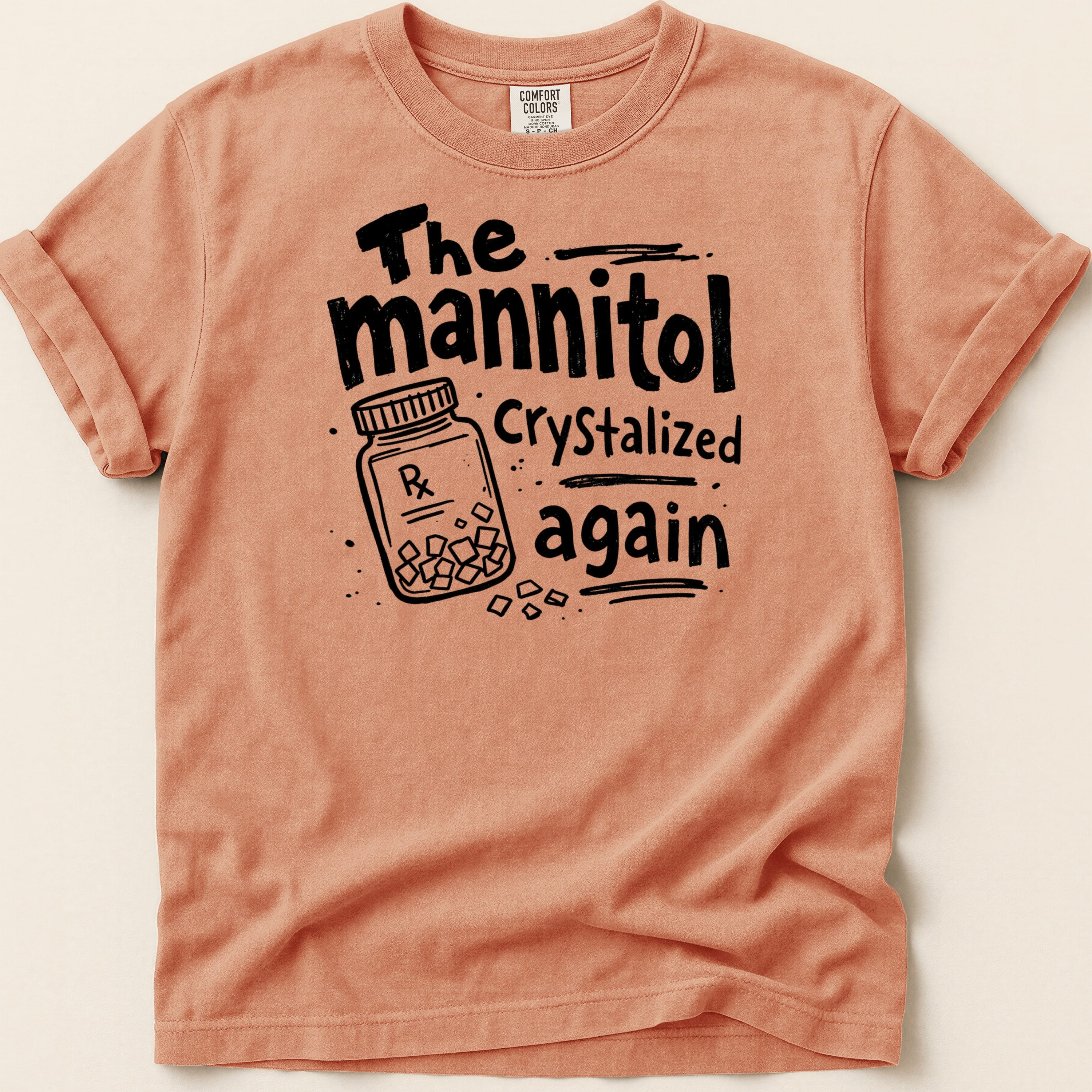 Peach t-shirt with black text: "The mannitol Crystalized again" and a Rx pill bottle.