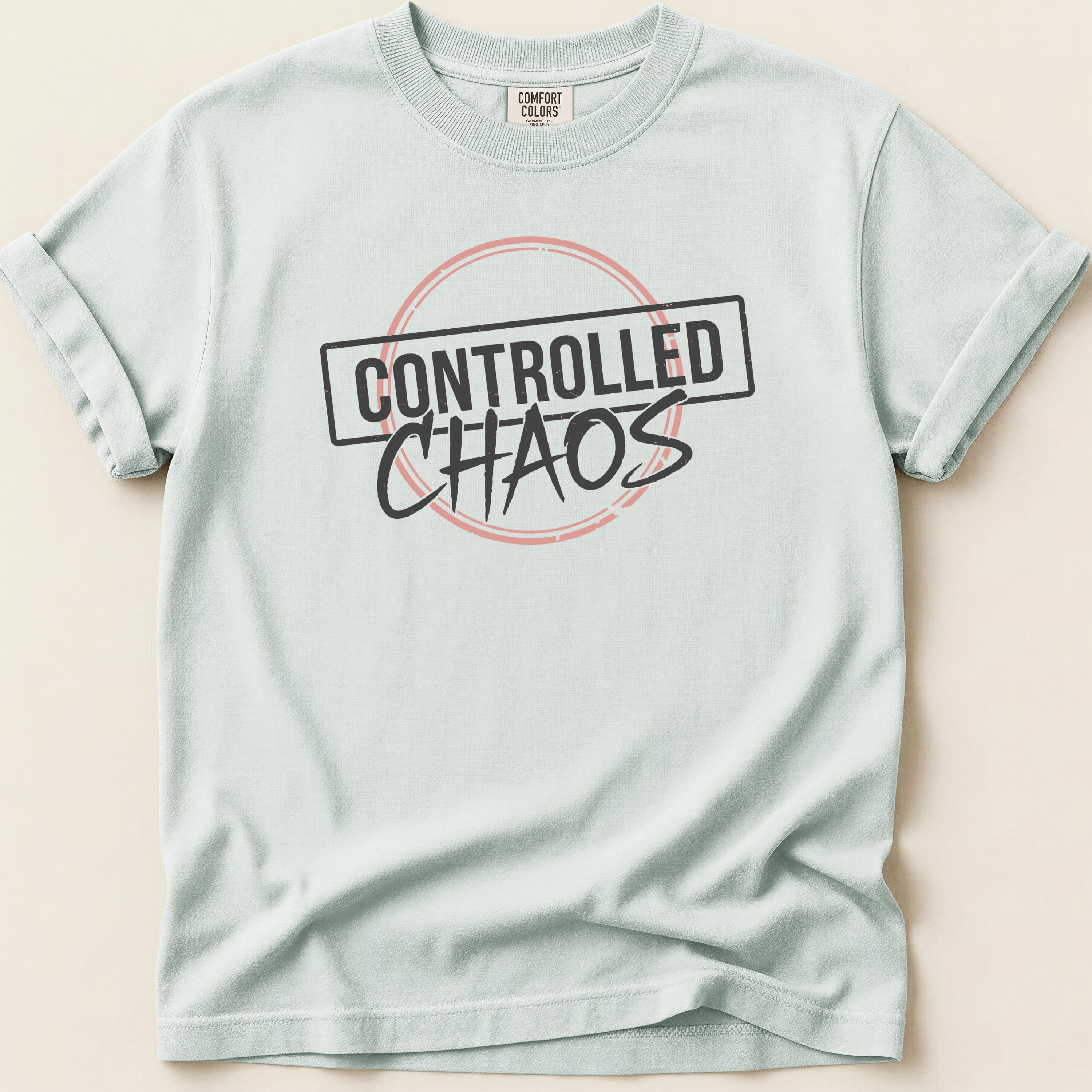 Light blue t-shirt with "CONTROLLED CHAOS" in black text within a red circle.