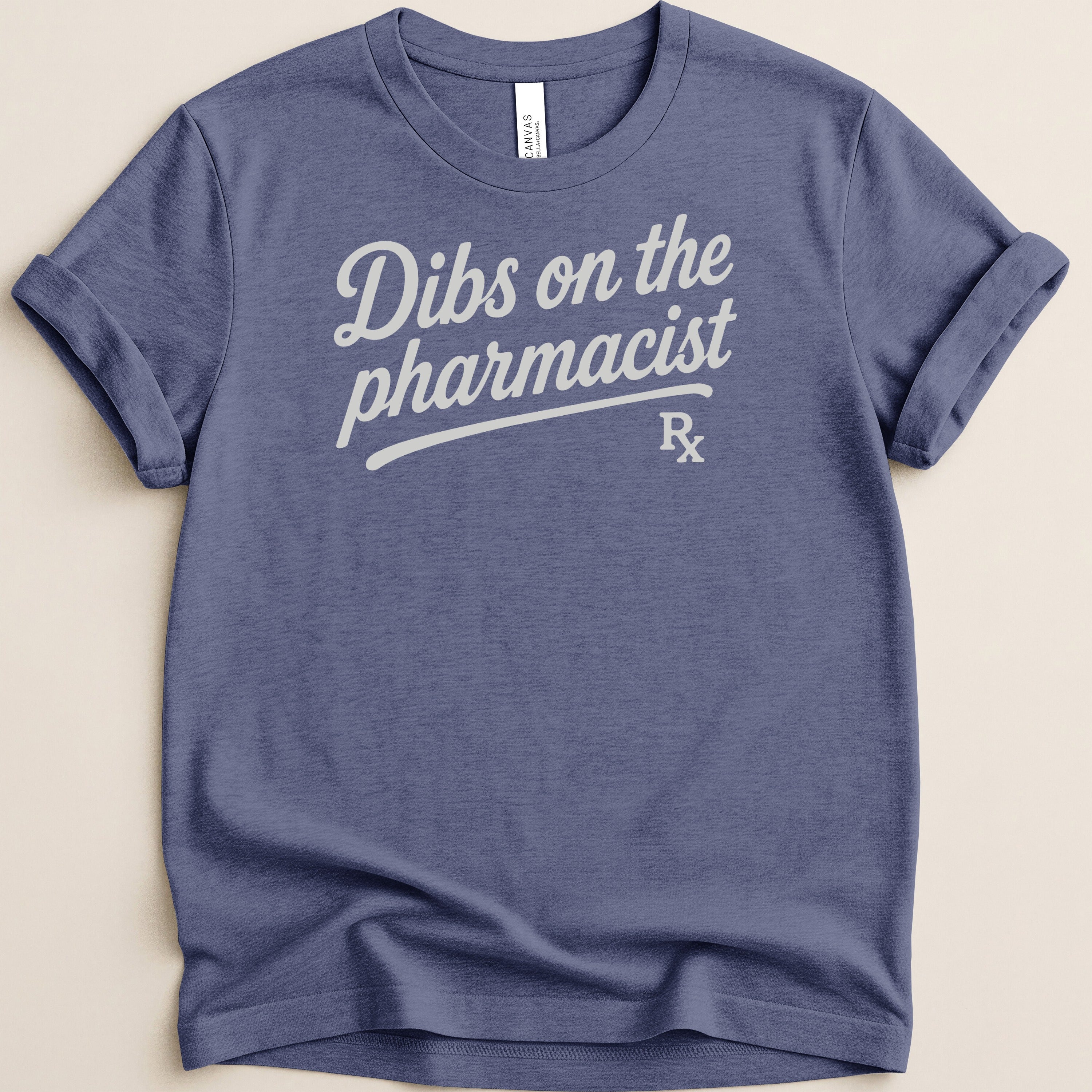 Blue t-shirt with "Dibs on the pharmacist Rx" graphic.