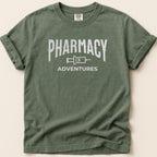 Green t-shirt with "Pharmacy Adventures" graphic in white.