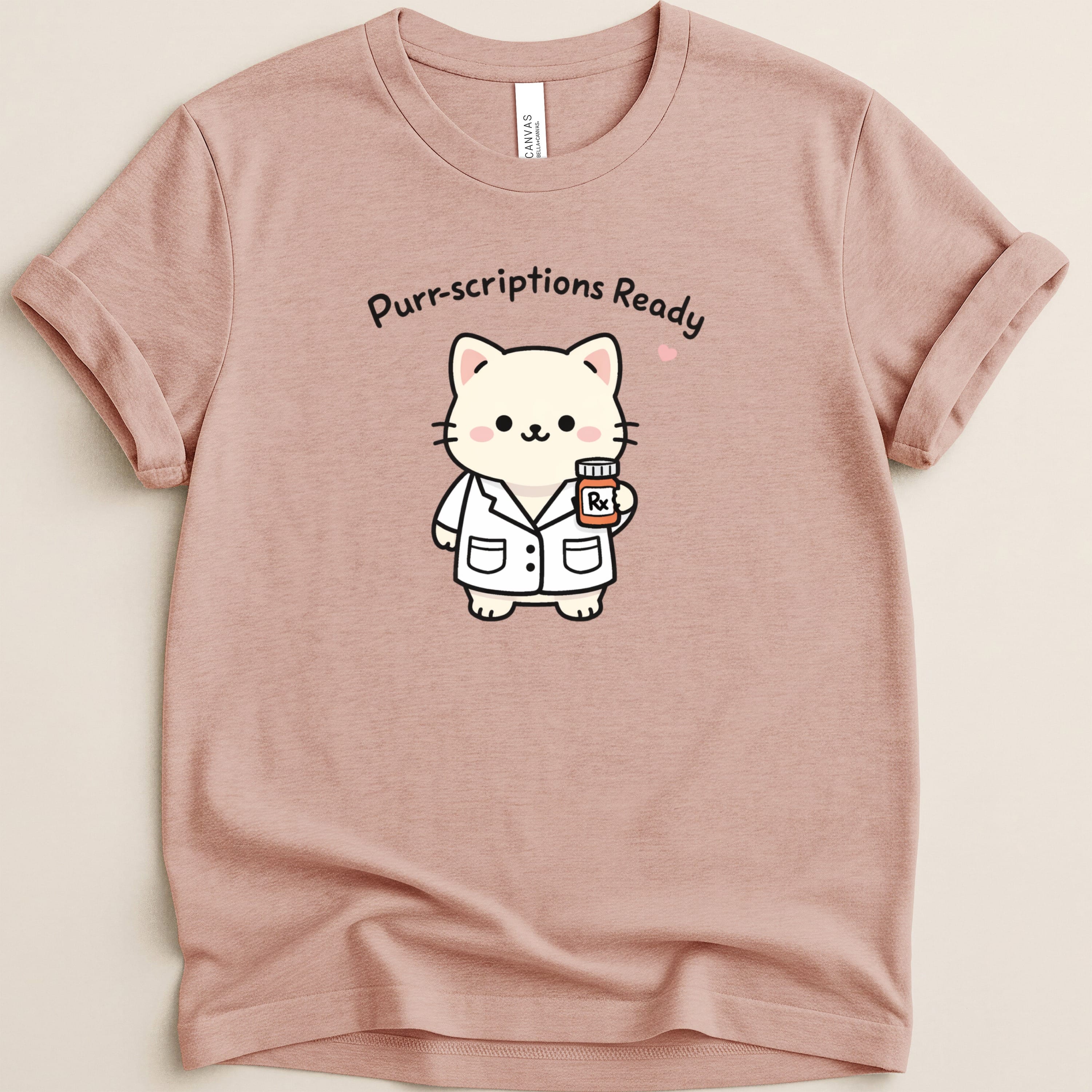 T-shirt with cartoon cat in lab coat holding pill bottle, "Purr-scriptions Ready" text.