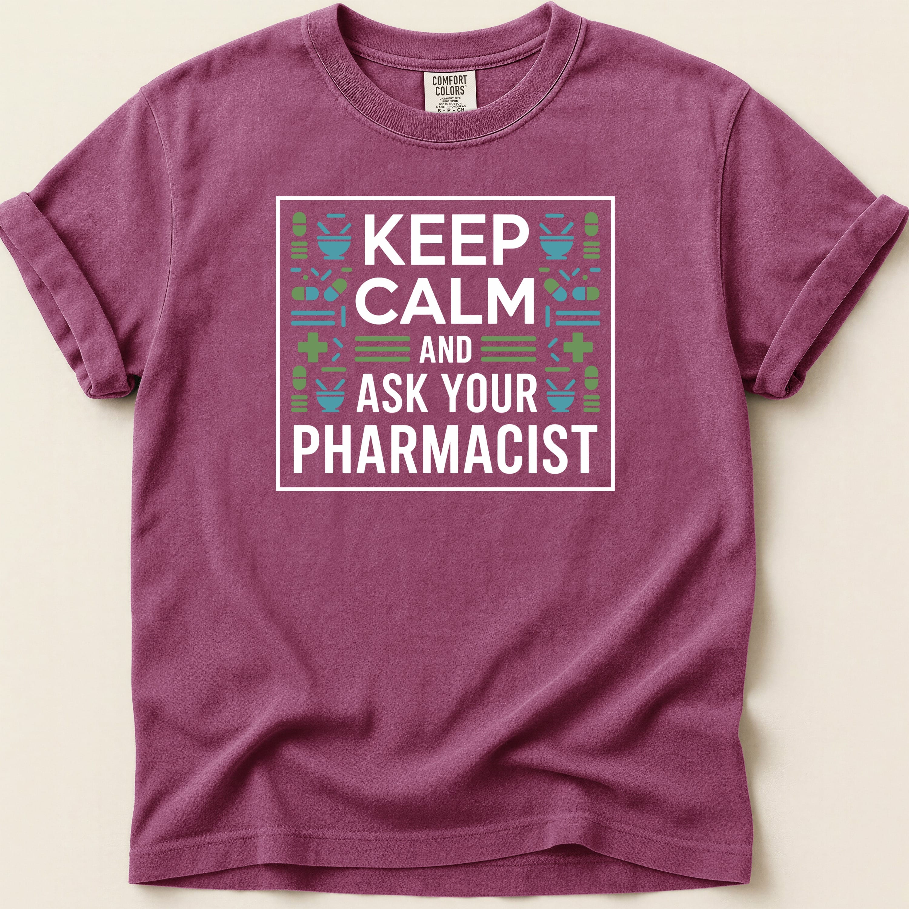 T-shirt with "Keep Calm and Ask Your Pharmacist" slogan and pharmacy icons.