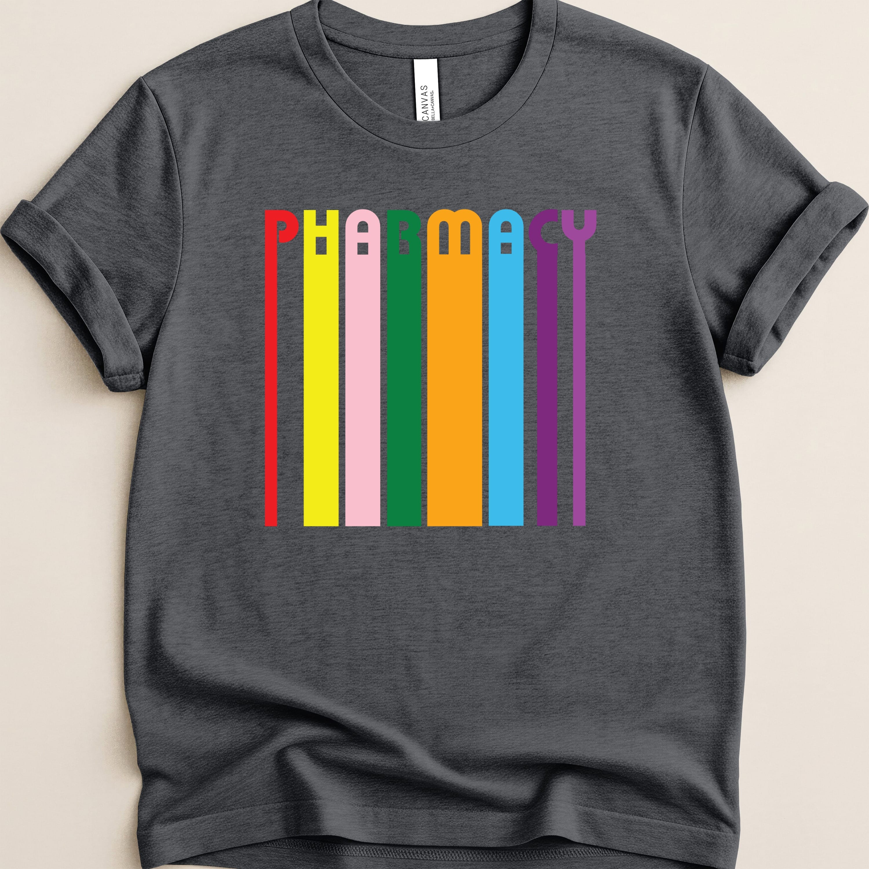 Dark t-shirt with colorful vertical stripes spelling "Pharmacy".