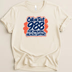 Cream t-shirt with "Call or Text 988 For Mental Health Support" graphic.