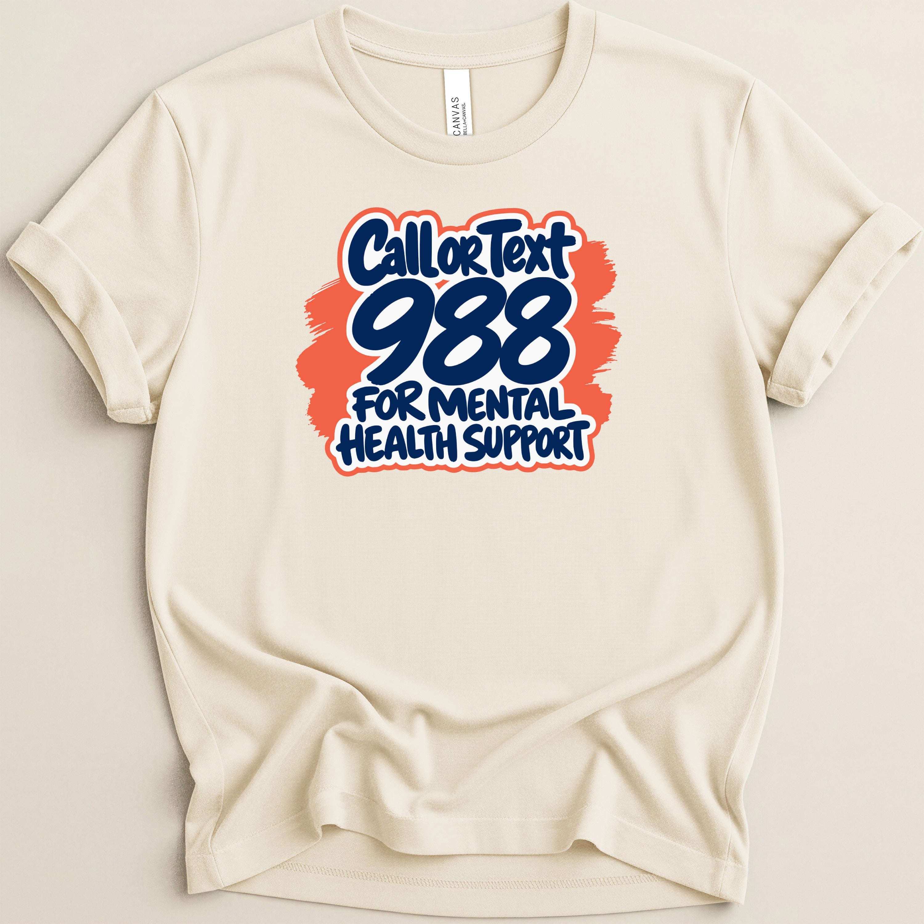 Cream t-shirt with "Call or Text 988 For Mental Health Support" graphic.