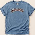 Blue t-shirt with "Pharmacy" text in red, white, and blue arched design.