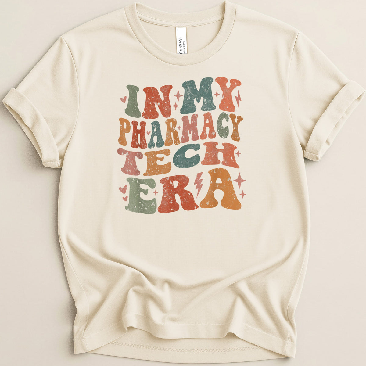Cream t-shirt with "In My Pharmacy Tech Era" text in distressed retro font.