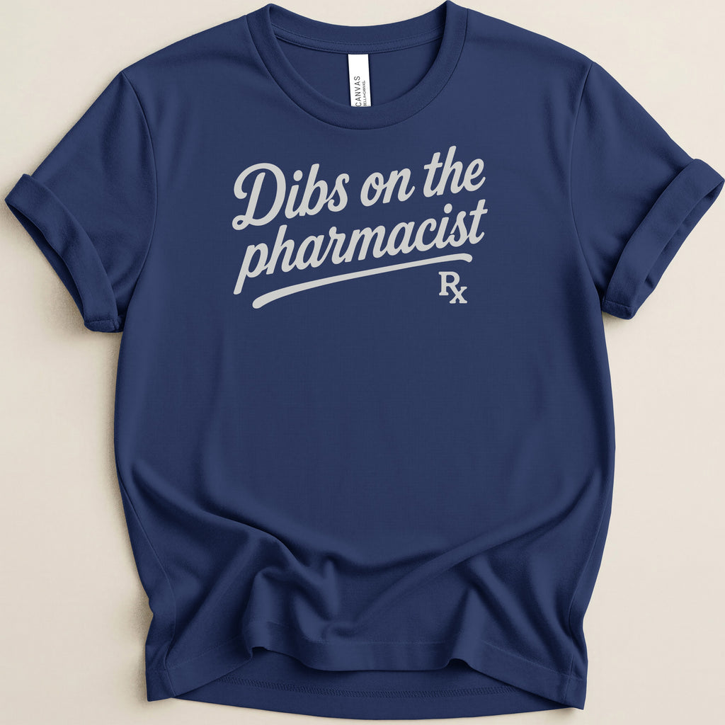 Navy t-shirt with white text that says "Dibs on the pharmacist" and a Rx symbol.