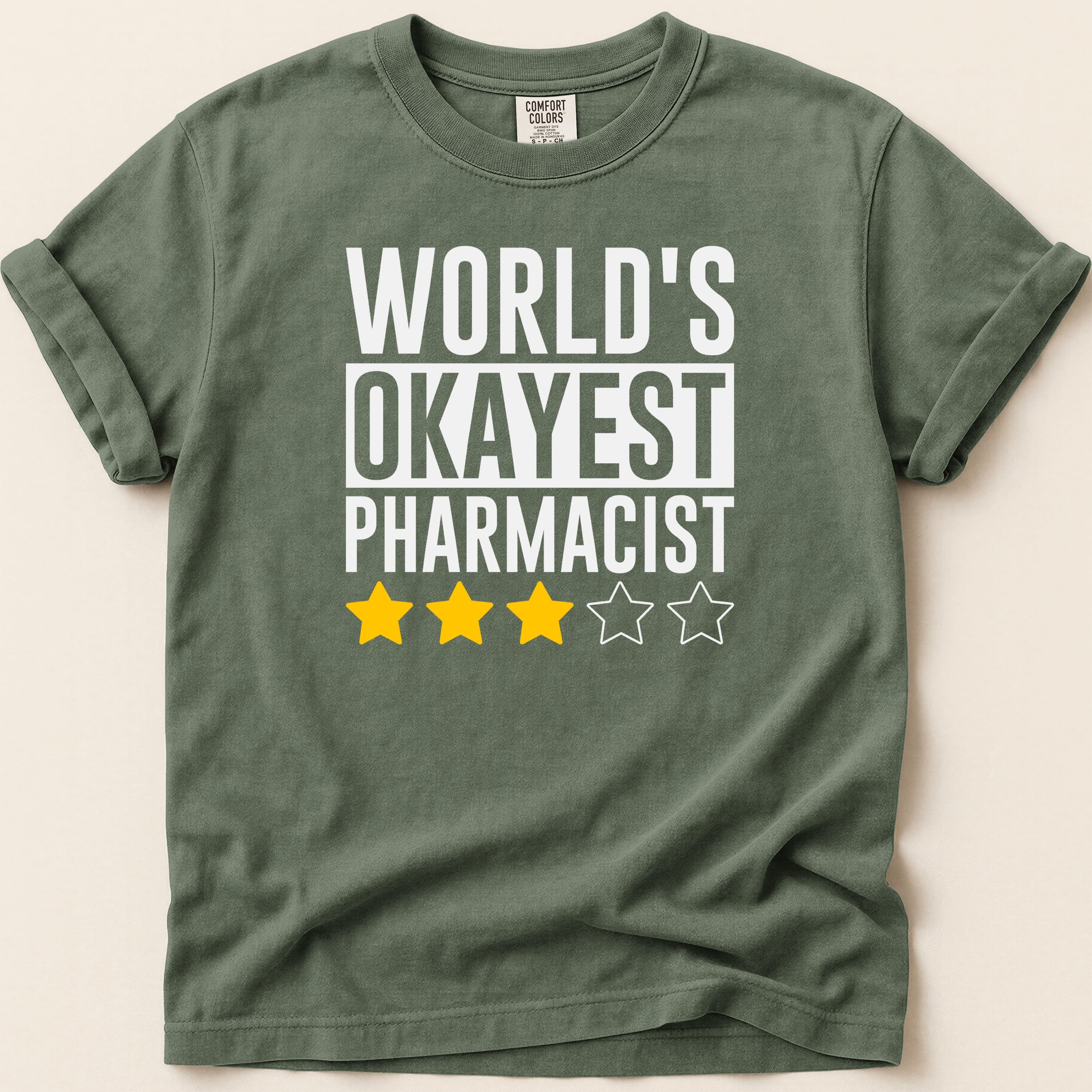 T-shirt with "World's Okayest Pharmacist" and three yellow stars.