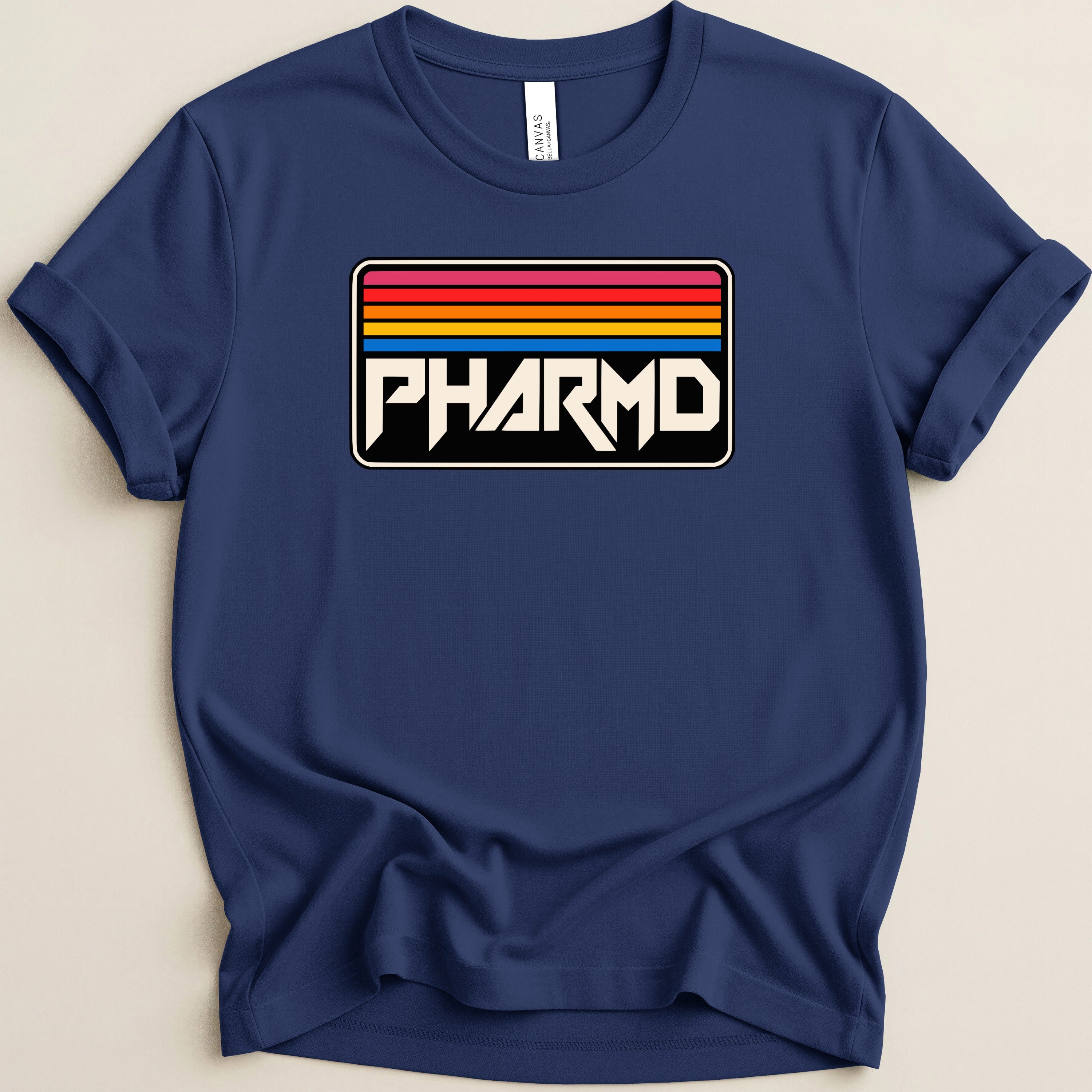 Navy blue t-shirt with a white "PHARMD" graphic against a sunset stripe background.