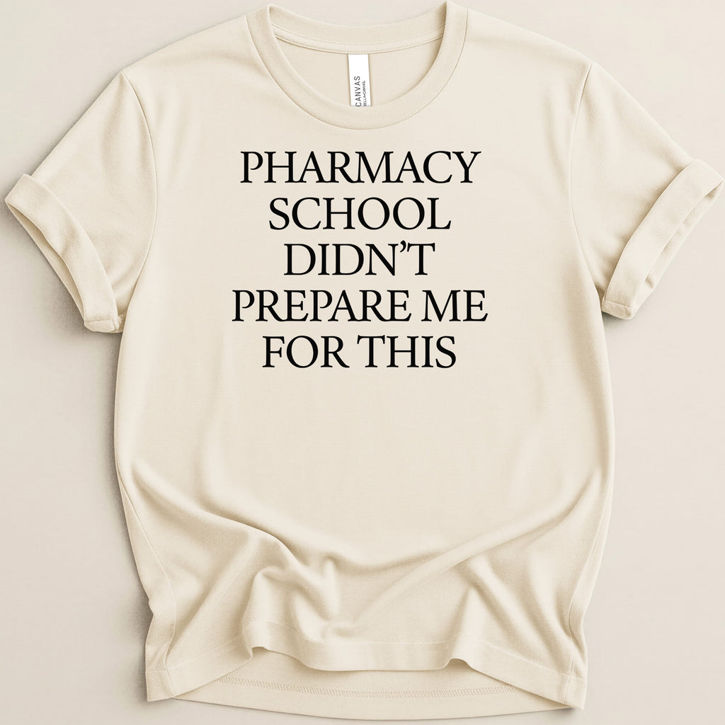 Cream t-shirt with "Pharmacy School Didn't Prepare Me For This" text.