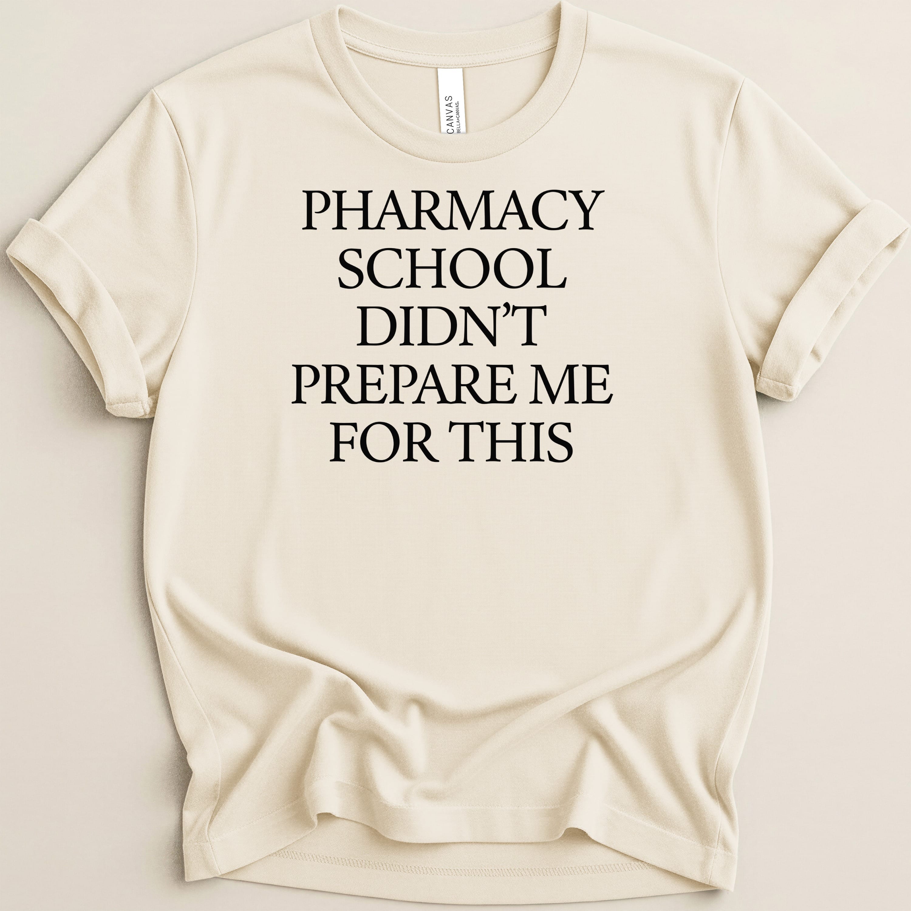 Cream t-shirt with "Pharmacy School Didn't Prepare Me For This" text.