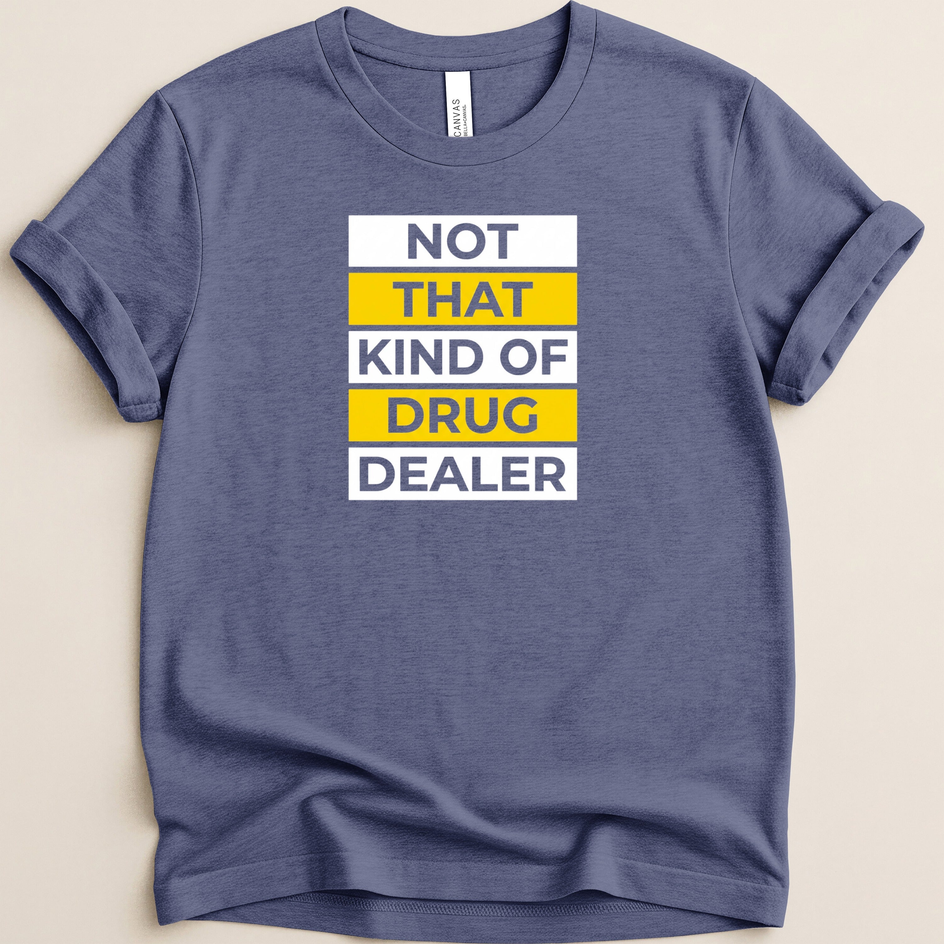 Blue t-shirt with white and yellow text that reads "NOT THAT KIND OF DRUG DEALER".