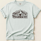 Light blue t-shirt with "Trust Your Pharmacist" text and starburst design.