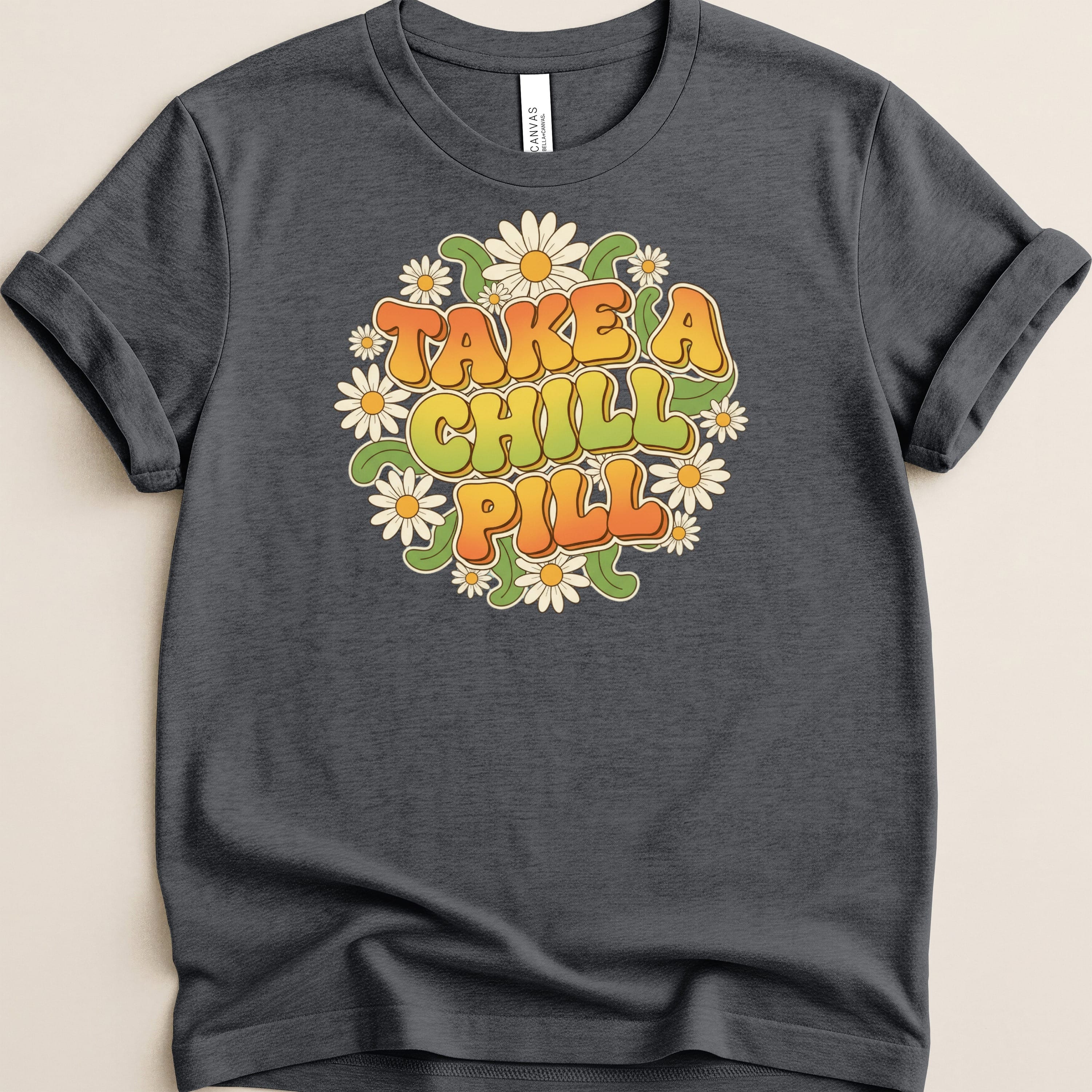 Dark t-shirt with "Take a Chill Pill" text surrounded by daisies.