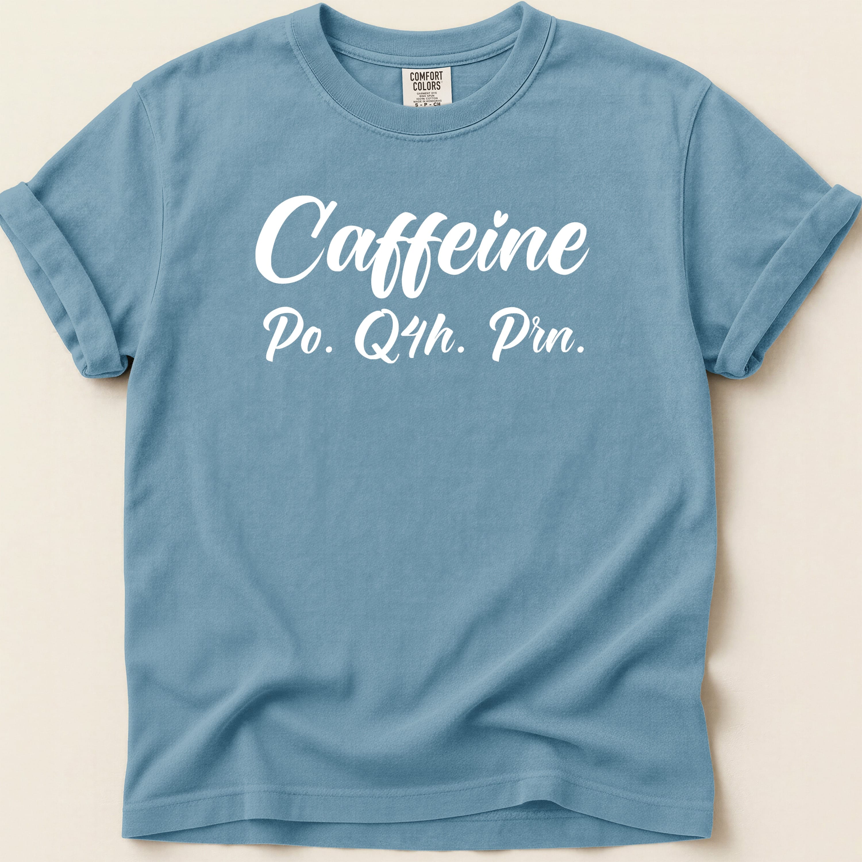 Blue t-shirt with "Caffeine Po. Q4h. Prn." text.