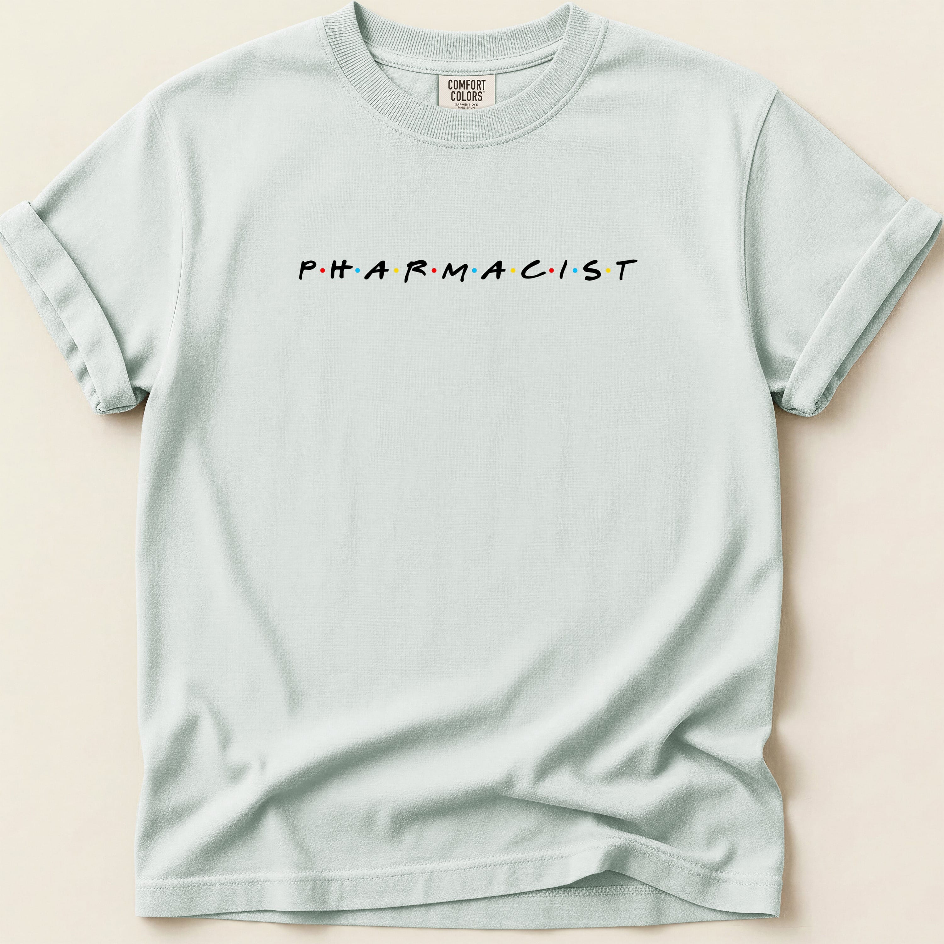 Comfort Colors t-shirt with "PHARMACIST" in the Friends font.