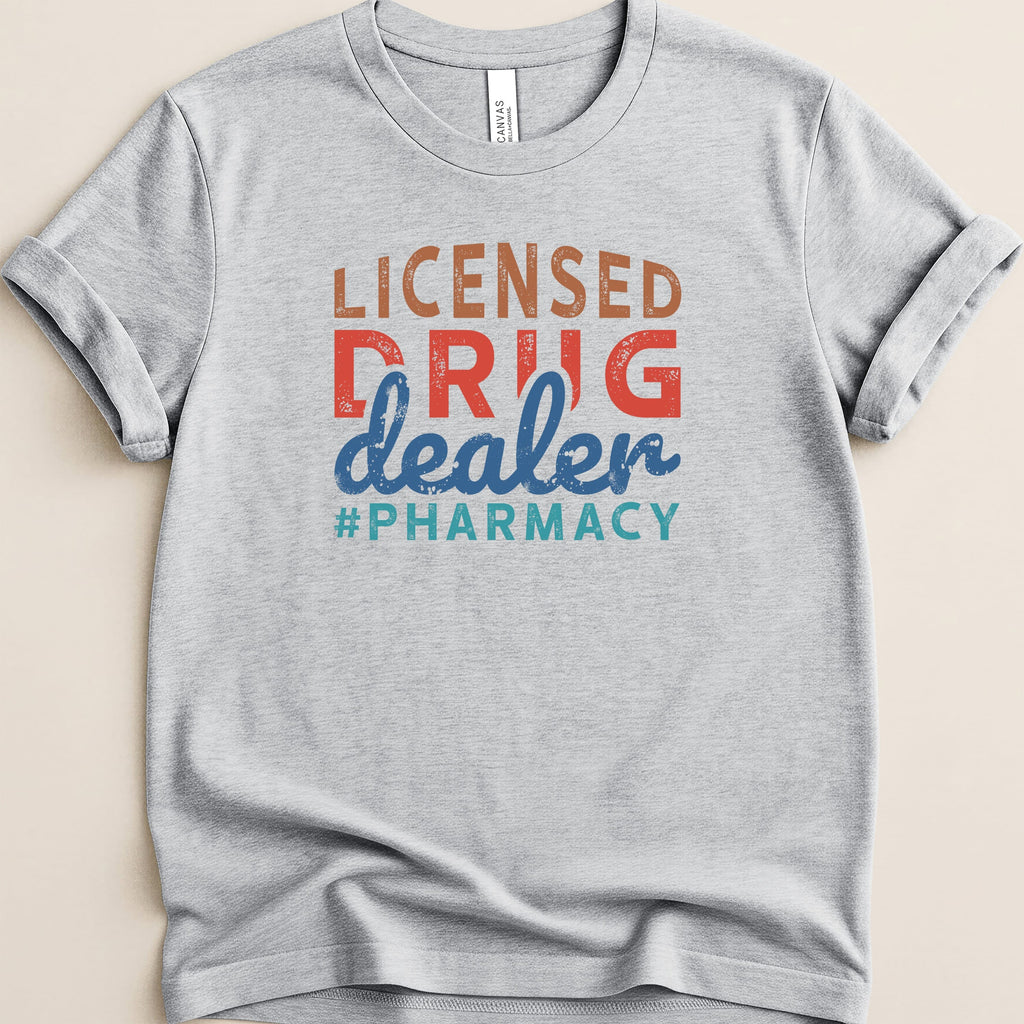 Light gray t-shirt with "Licensed Drug Dealer #Pharmacy" in colorful text.