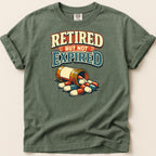 T-shirt with text "RETIRED BUT NOT EXPIRED" and a bottle of pills.