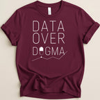 Maroon t-shirt with "DATA OVER DOGMA" and a pill on a line graph.