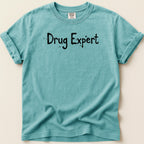 Teal t-shirt with "Drug Expert" printed in black, distressed lettering.