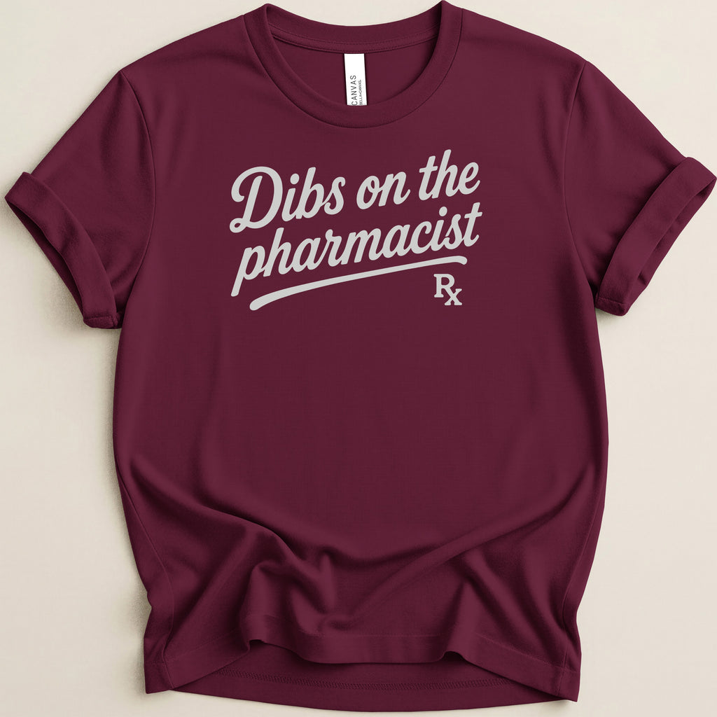 Maroon t-shirt with "Dibs on the pharmacist Rx" graphic in white script.