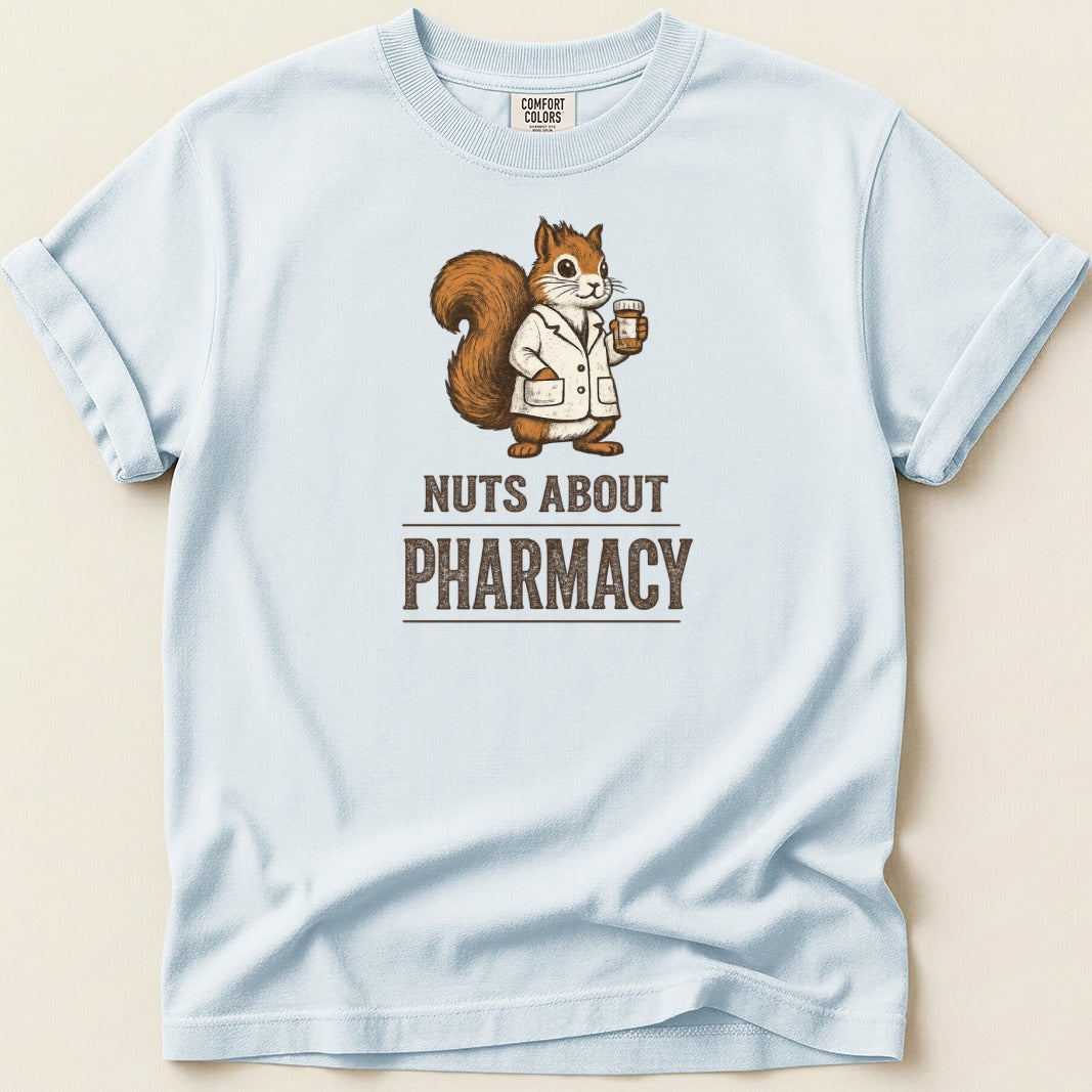 Light blue t-shirt with a squirrel wearing a lab coat holding a pill bottle, text reads "NUTS ABOUT PHARMACY".
