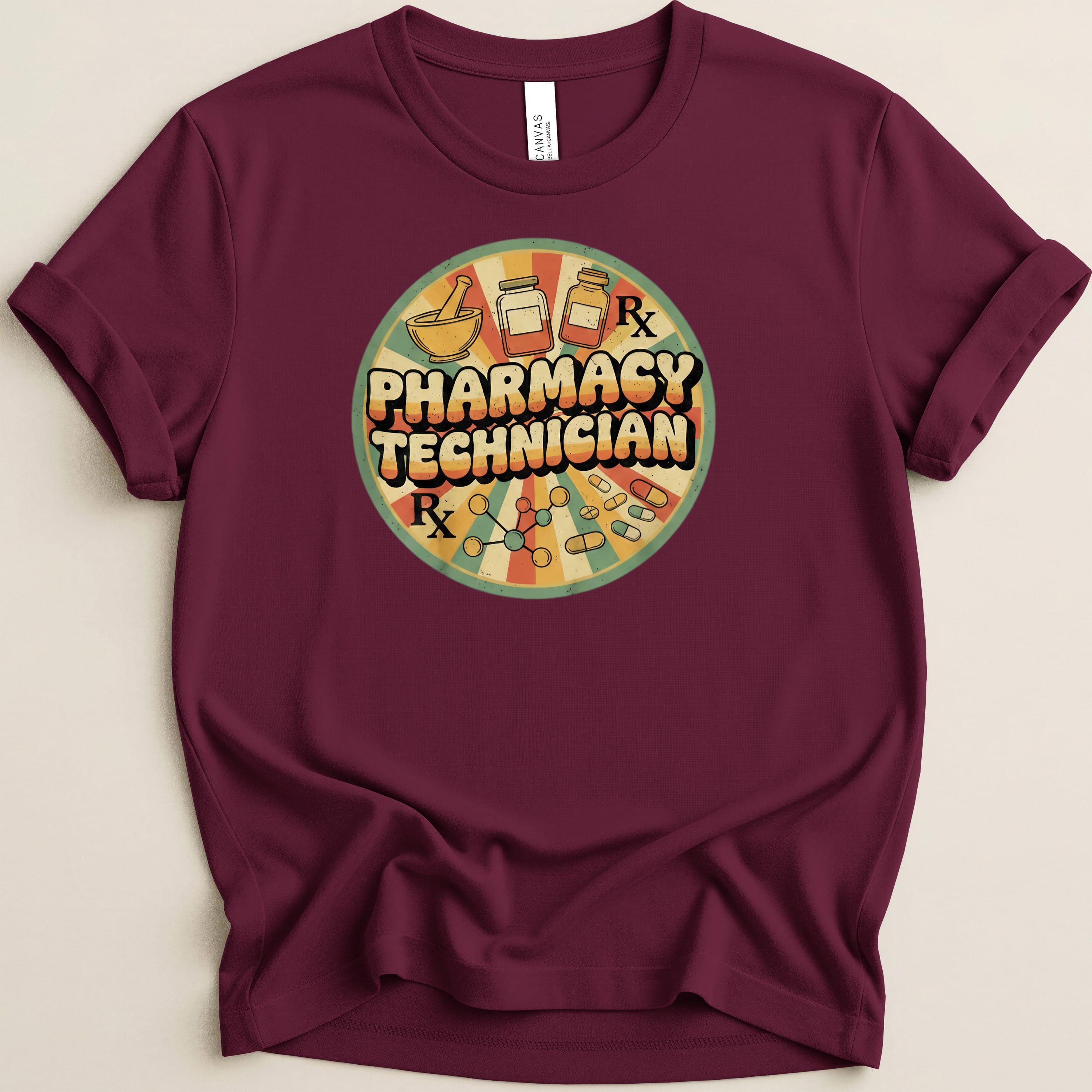 Maroon t-shirt with circular retro pharmacy technician graphic featuring Rx symbols and pills.