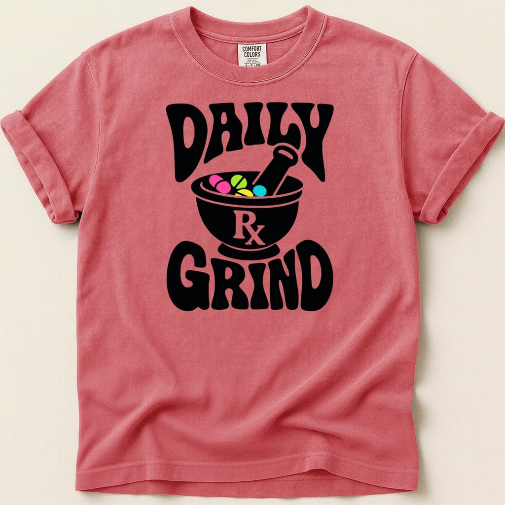 T-shirt with "Daily Rx Grind" text and mortar, pestle, and pills graphic.