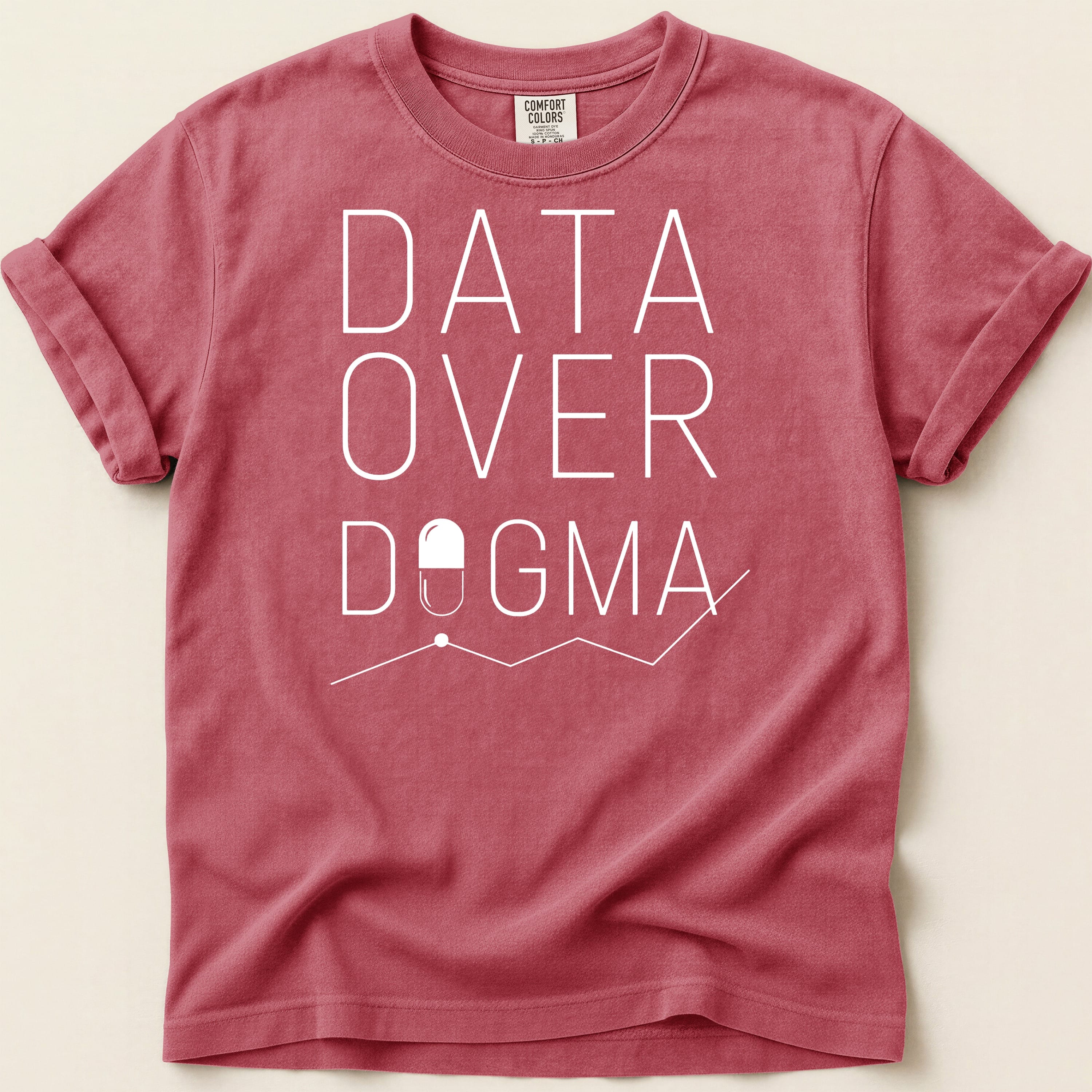 Red t-shirt with "DATA OVER DOGMA" text and a pill icon.