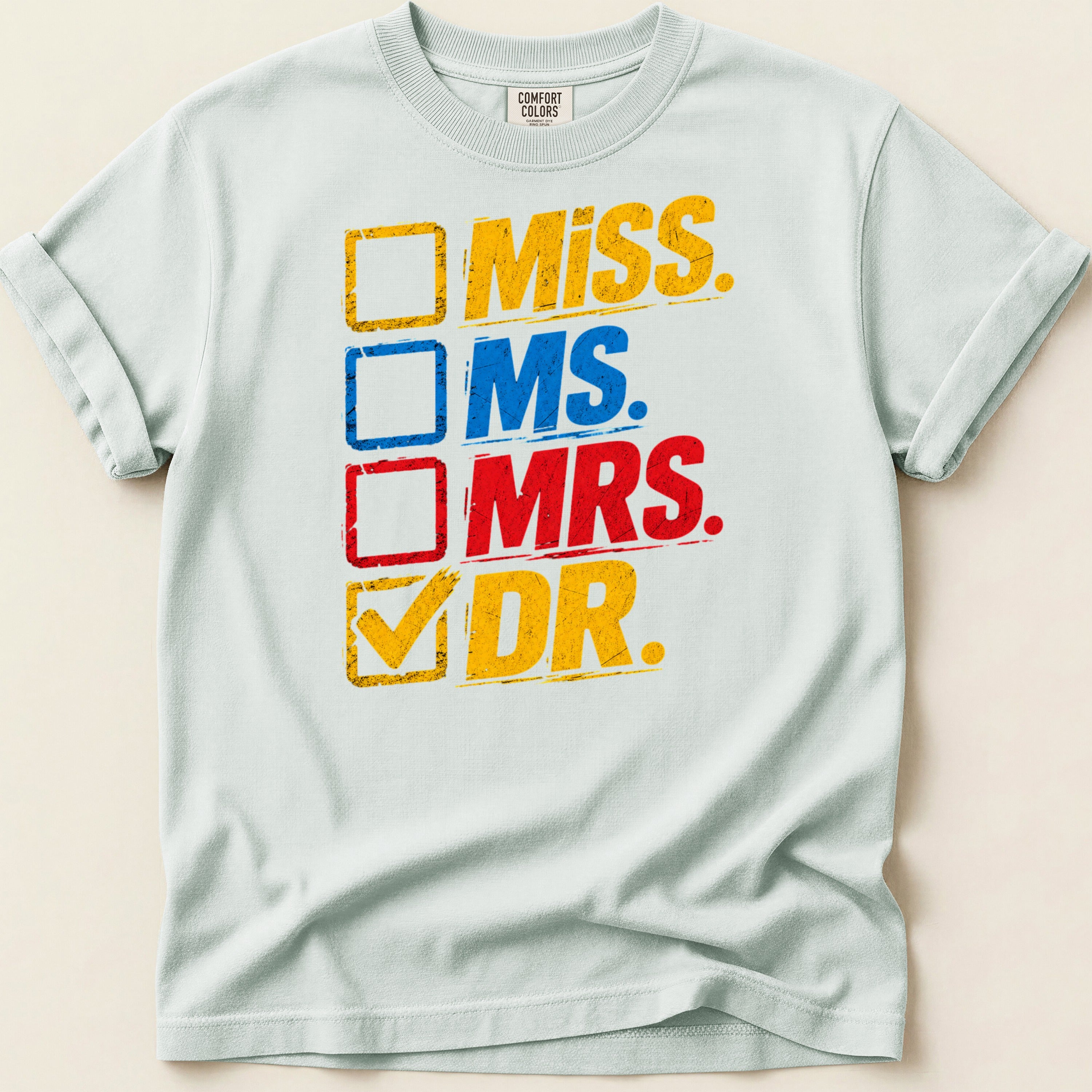 Light blue t-shirt with check boxes labeled Miss, Ms., Mrs., and Dr.