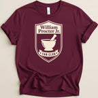 Maroon t-shirt with William Procter Jr. Fan Club crest and mortar and pestle graphic.