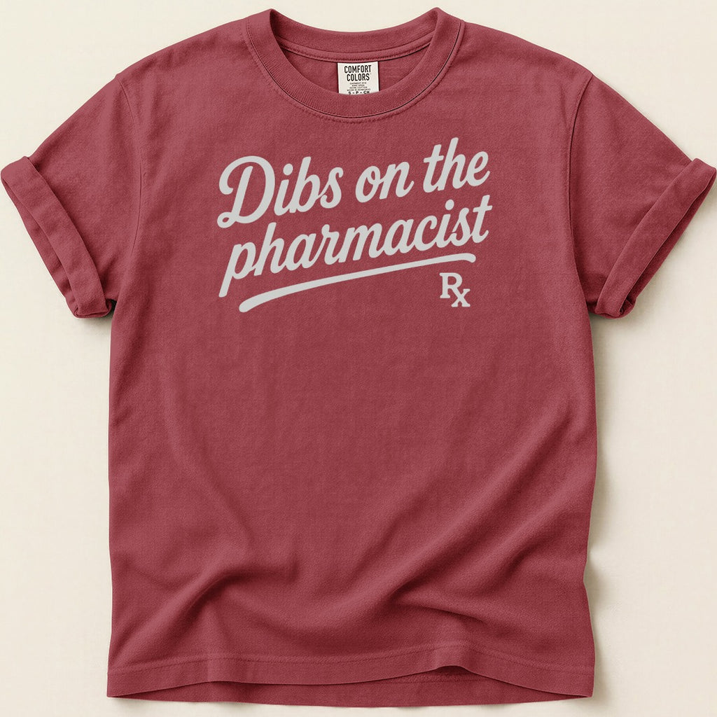 Burgundy t-shirt with "Dibs on the pharmacist" graphic and Rx symbol.
