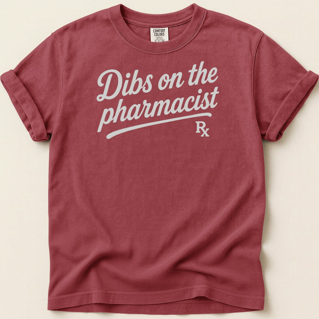 Burgundy t-shirt with "Dibs on the pharmacist" graphic and Rx symbol.
