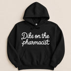 Black hoodie with white script text "Dibs on the pharmacist".