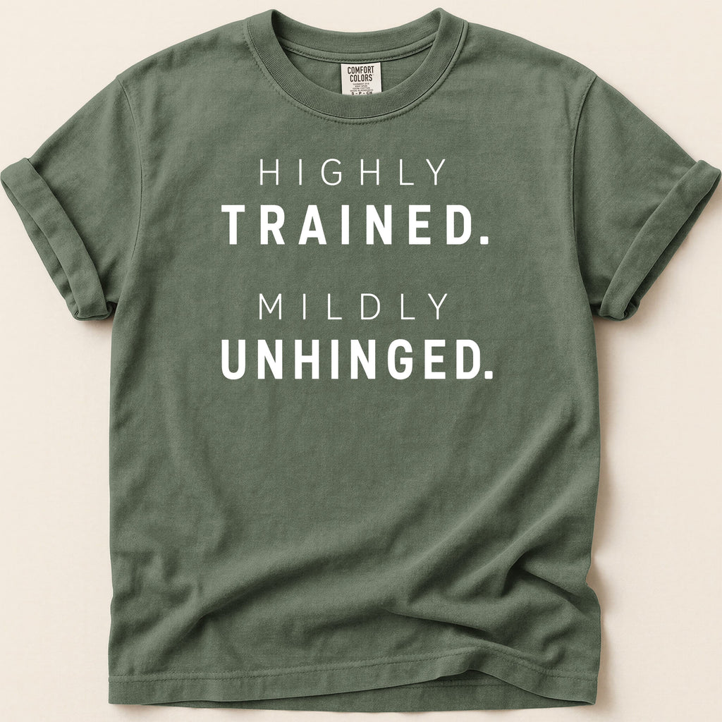Green t-shirt with "HIGHLY TRAINED. MILDLY UNHINGED." text.