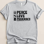 Grey t-shirt with black text: "Peace Love Pharmacy" and icons for heart and prescription.