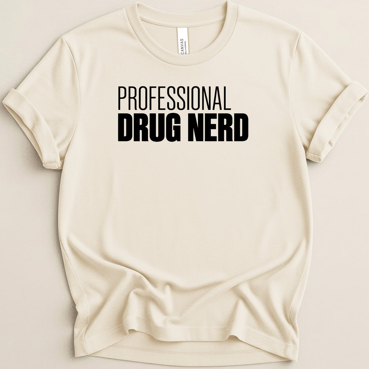 Cream t-shirt with black text reading "PROFESSIONAL DRUG NERD"