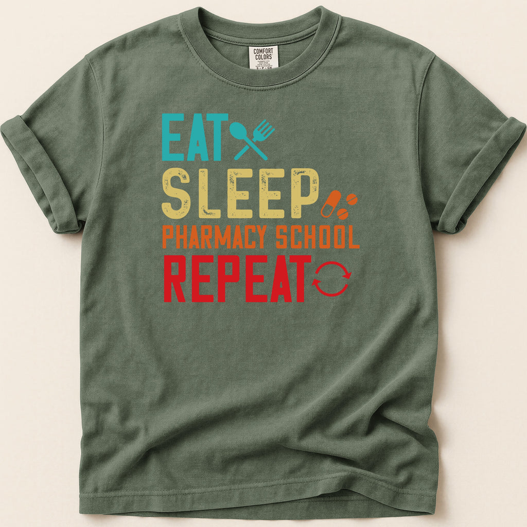 Green t-shirt with "Eat Sleep Pharmacy School Repeat" text.