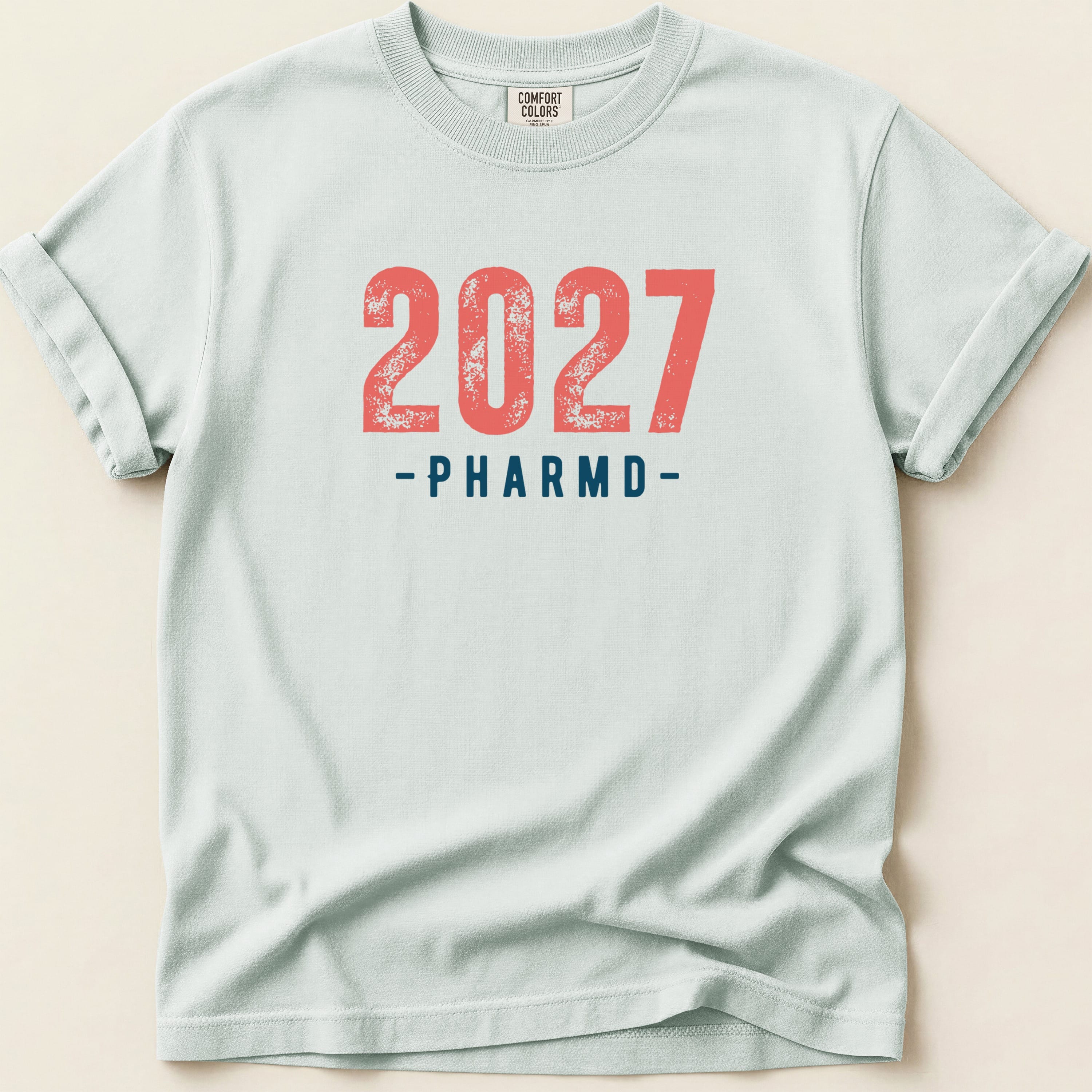 Light blue t-shirt with "2027 -PHARMD-" printed in red.