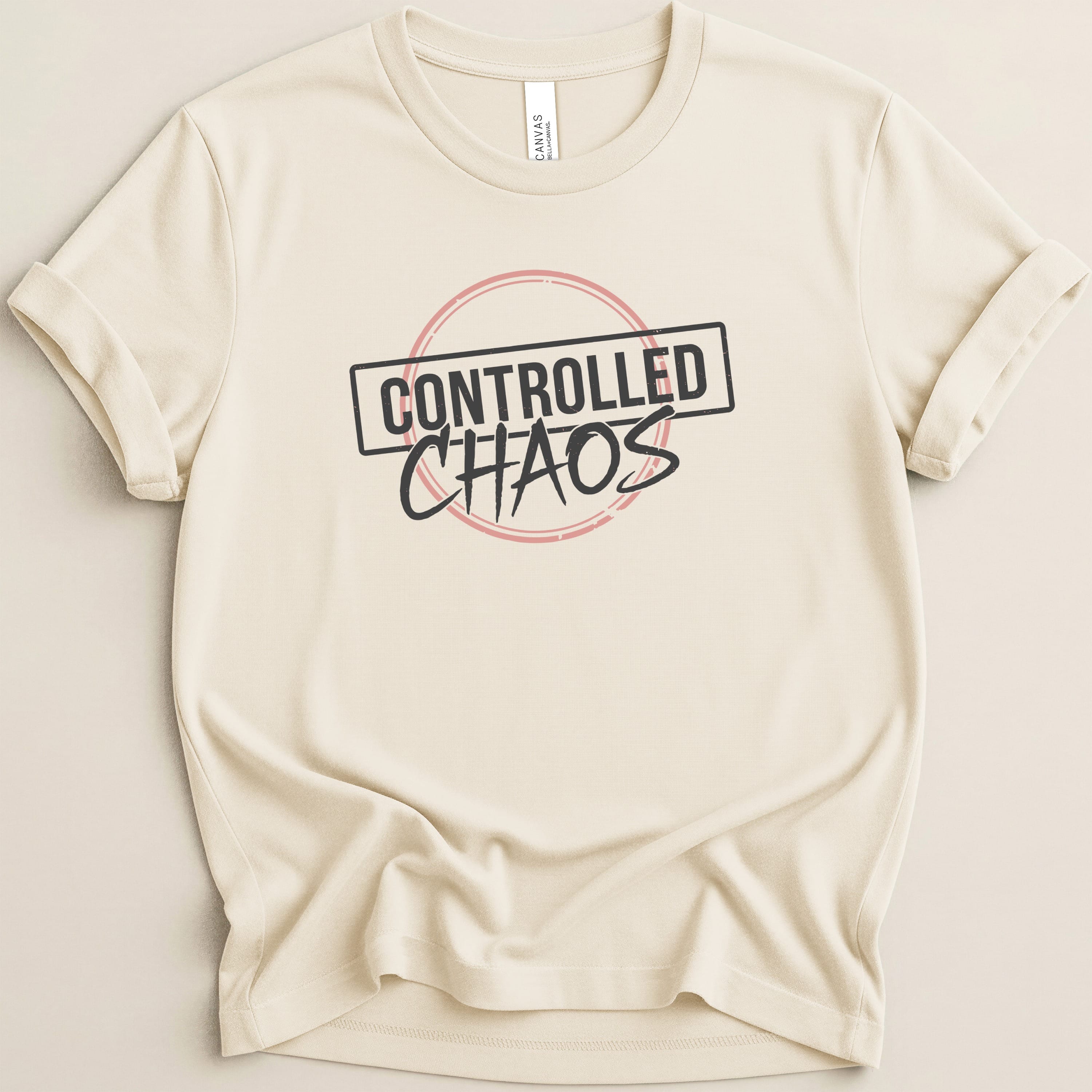 Cream t-shirt with "CONTROLLED CHAOS" text in a circular red and black graphic.